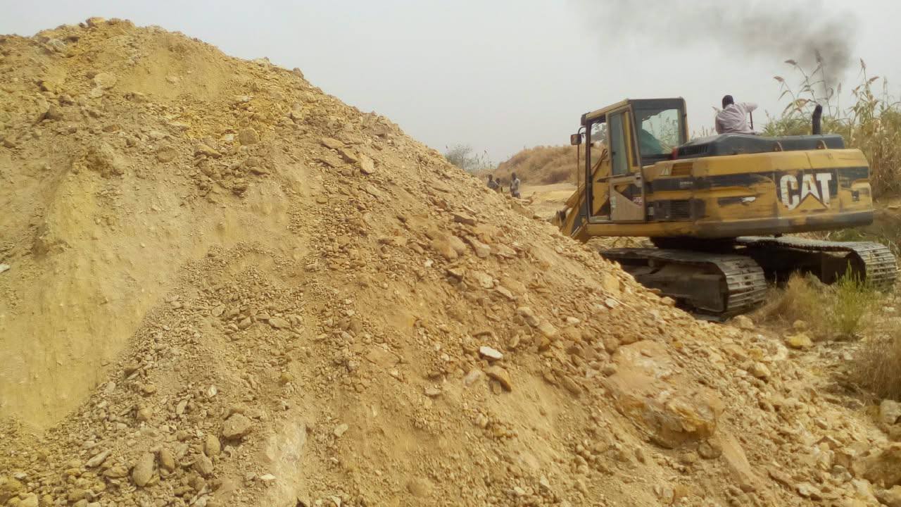 Heavy Caterpillar excavator at Bakobabs mining concession site